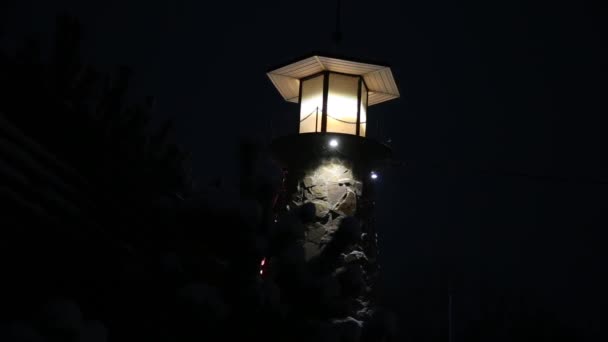 Vuurtoren knippert en spinnen bij nacht. Licht signalering voor schepen en boten — Stockvideo