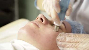 Elmas mikrodermabrazyon, kozmetik güzellik spa kliniğinde tedavi soyulması. kadın bir vakum mikrodermabrazyon yordam Başlarken
