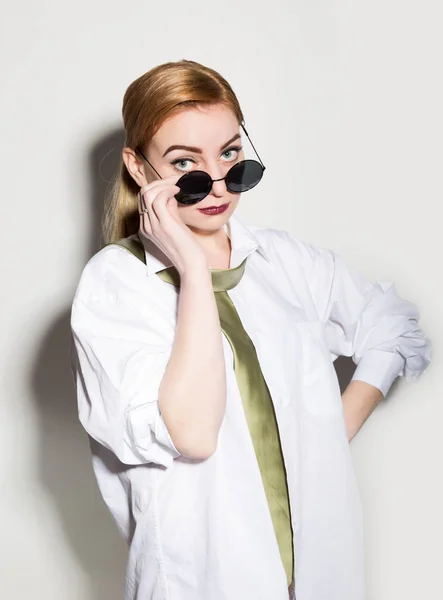 Naked young woman in a mans white shirt with green tie wears glasses and smiling — Stock Photo, Image