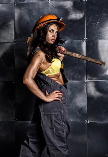 Sexy female miner worker with pickaxe, in coveralls over his naked body — Stock Photo, Image