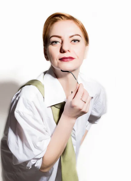 Naked young woman in a mans white shirt with green tie holding glasess — Stock Photo, Image