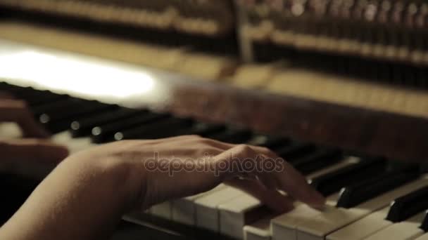 Крупным планом женские руки играют на пианино на темноте — стоковое видео