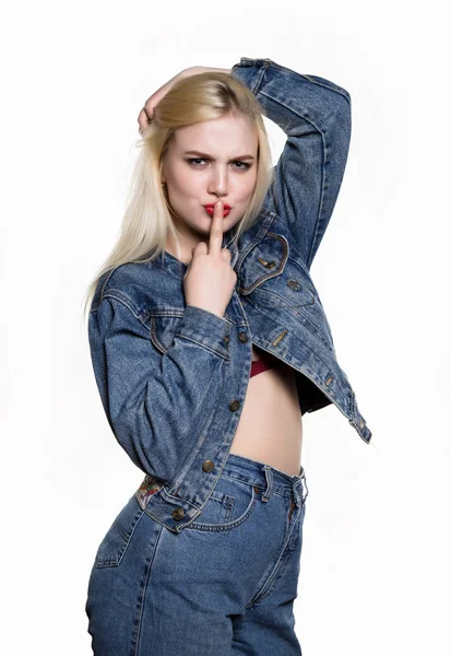 Sporty girl in denim jaket and jeans show middle finger, fuck you off sign on white background. indecent lifestyle concept — Stock Photo, Image