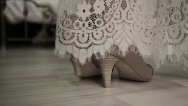 First wedding night. bride comes to a bed, removes shoes and lace dress — Stock Video