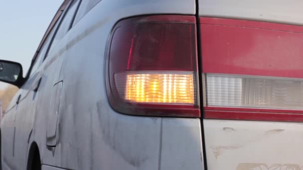 Knipperend oranje blinker licht op licht aan de achterzijde. auto op een zijlijn — Stockvideo