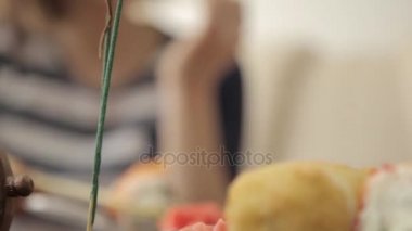 rulo çubukla yemekte restoranda yemek iki kız arkadaşım. yakın çekim Japon mutfağı