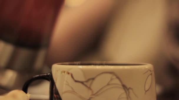 Close-up cup of tea, woman pours tea into a cup — Stock Video