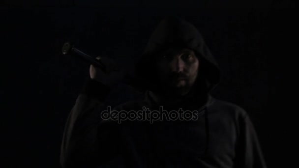 Bandit, hooligan or football fan with baseball bat attacks on dark background — Stock Video