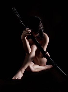 beautiful sexy woman with samurai sword on black backgound clipart