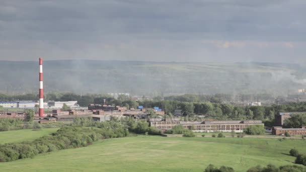 Air pollution above smole city. Pipes throwing smoke towards the city — Stock Video