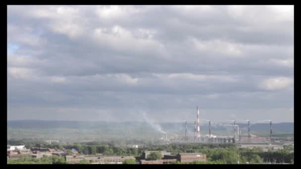 Air pollution above smole city. Pipes throwing smoke towards the city — Stock Video