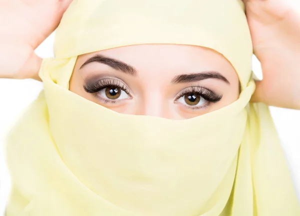 Closeup of beautiful young arabian woman in yellow hijab. Charm and beauty of the East. — Stock Photo, Image