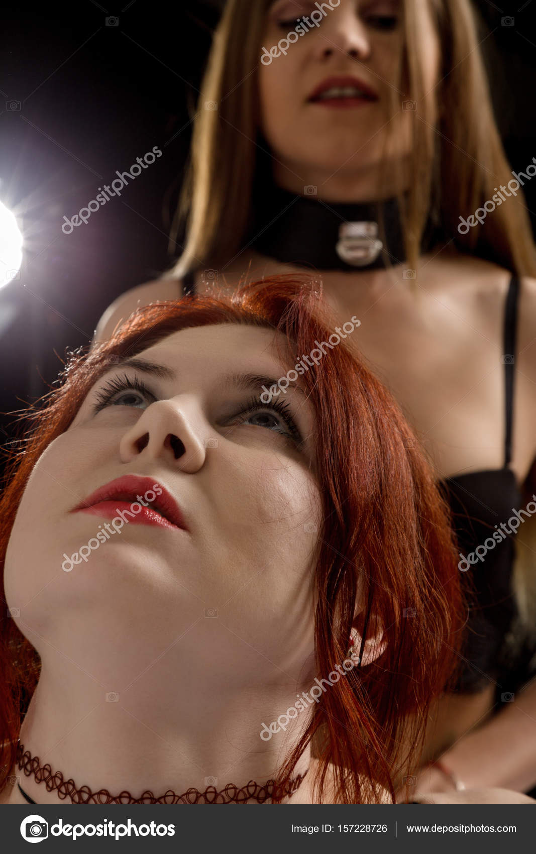 Two Bisexual girls hug on a dark background. BDSM concept Stock Photo by  ©sandy-che.yandex.ru 157228726