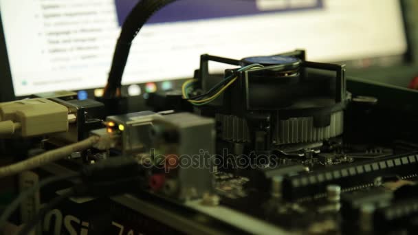 Computer motherboard - processor fan and network card on a monitor background — Stock Video