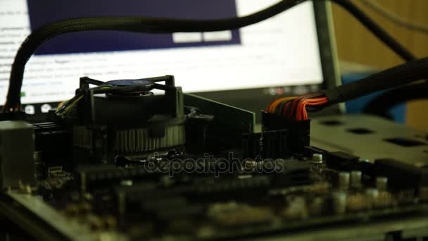 Computer motherboard - processor fan and network card on a monitor background — Stock Video
