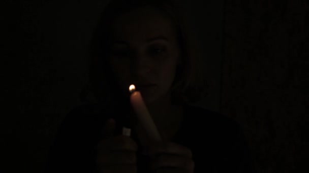 Beautiful women lighting candles in a dark — Stock Video