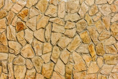 taştan bir duvar, kahverengi bej tonları arka plan veya doku parçası.