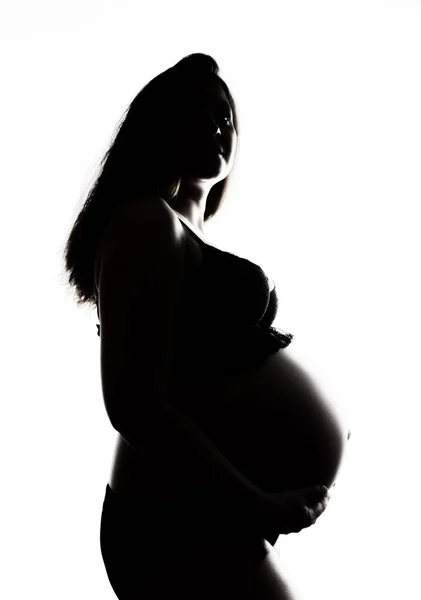 Silhouette d'une belle femme enceinte sur fond blanc — Photo