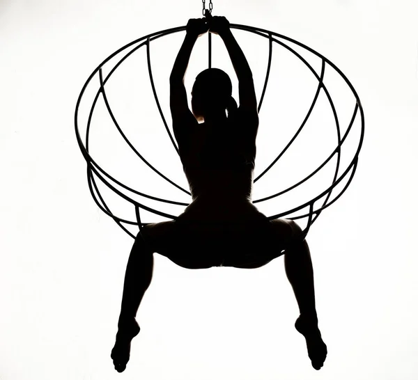 Silhouette of a sexy woman on a metal swing, black and white — Stock Photo, Image