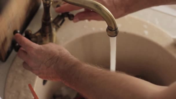 Primer plano mans manos lava una vajilla, chorro de agua enjuaga las placas de espuma y detergente — Vídeos de Stock