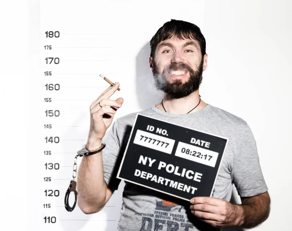 Bearded man in handcuffs with sigarette, Criminal Mug Shots — Stock Photo, Image