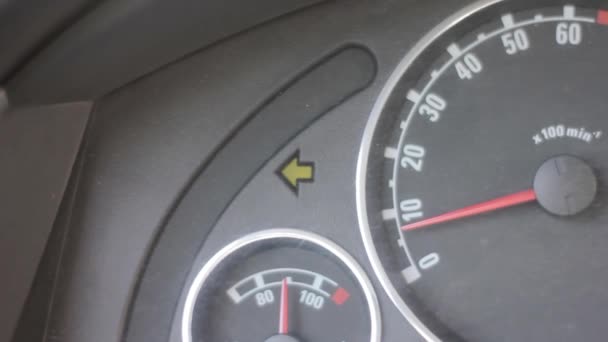Vehicle turn signal indicator. car dashboard with blinking green arrow