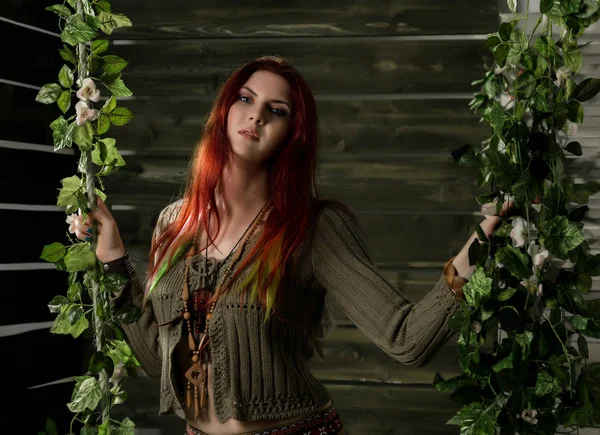 Young hippie boho redhead woman having fun on a swing. Hippie style on a wooden background — Stock Photo, Image