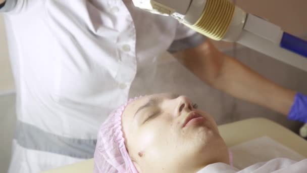 Beautiful females face with closed eyes being cleaned with steam therapy in beauty spa — Stock Video