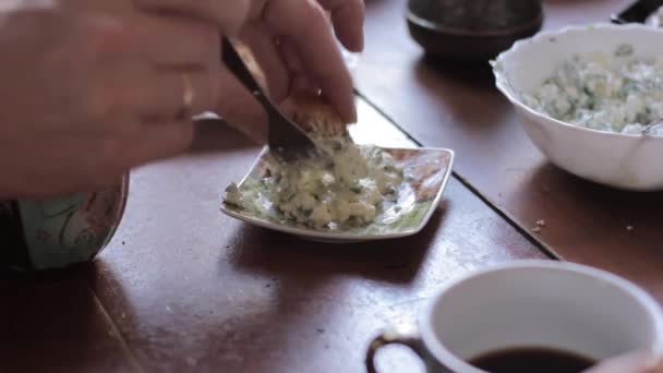 Rural breakfast, child smears a pate on a piece of bread — Stock Video