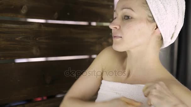 Beautiful young woman wrapped in towel. Skin care and home Spa — Stock Video