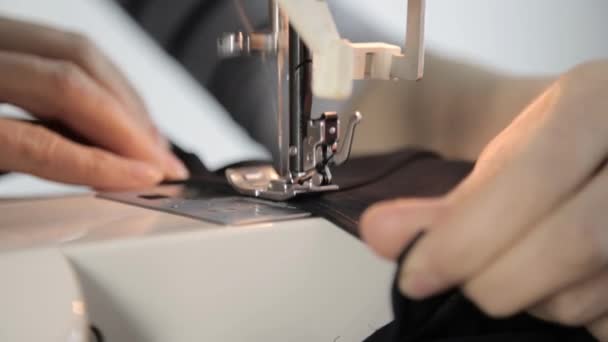 Máquina de costura e mãos de mulher, costureira que apoia um tecido — Vídeo de Stock