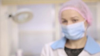 Beyaz önlük ve pill tutarak koruyucu eldiven içinde tıbbi profesyonel