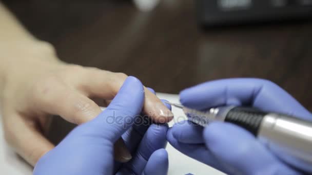 Manikyr gör en manikyr i en nagelsalong. kvinna med en spik verktyg för att ge en manikyr. — Stockvideo