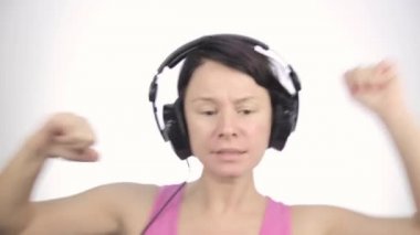 büyük kulaklık ile müzik dinleme ve hafif bir arka plan üzerinde dans esmer kadın