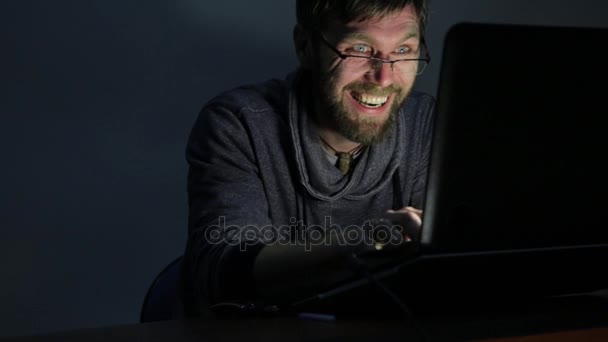 Very happy bearded man working on laptop and begins to very surprised and upset — Stock Video