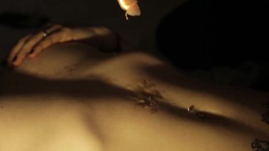 bir mum balmumu çıplak bir vücut üzerine damlar. kaç intimal bir an içinde