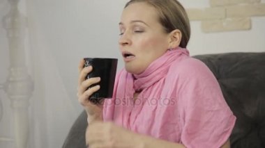 hasta bir kadın yüksek sesle hapşırma, burnunu silinerek ve ve sıcak çay içme