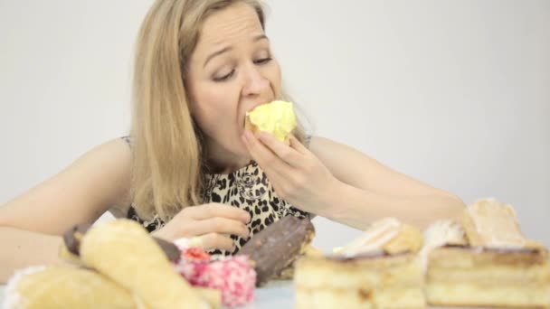 Frossare kvinna äta cupcakes med frenesi efter lång diet — Stockvideo