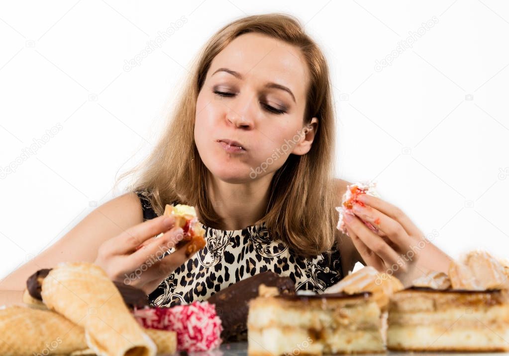 glutton woman eating cupcakes with frenzy after long diet