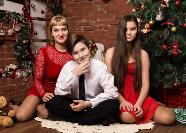 Happy family, mother with two children next to cristmas tree in Christmas day — Stock Photo, Image