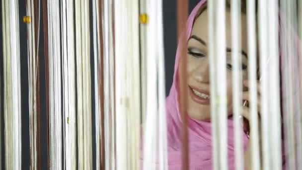 Young muslim arabian woman in pink hijab looking out the window and waving his hand to friends — Stock Video