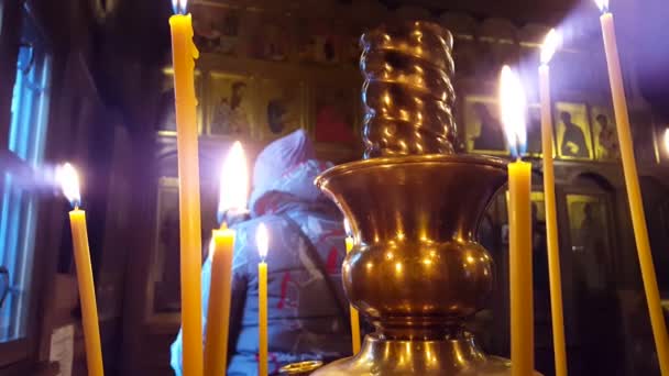 Collocare candele le persone chiedono perdono e benessere a Dio. Volti santi nell'icona su uno sfondo — Video Stock