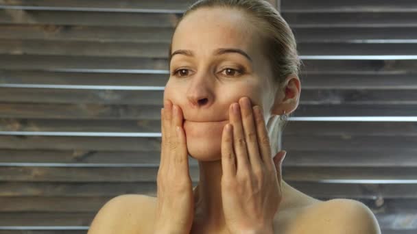 Woman performs anti-aging exercises. gymnastics for anti sagging face skin — Stock Video