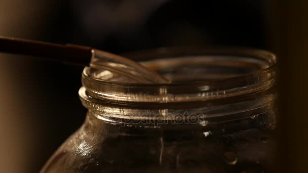 Production of strong drinks, drops of alcohol drip into a glass — Stock Video