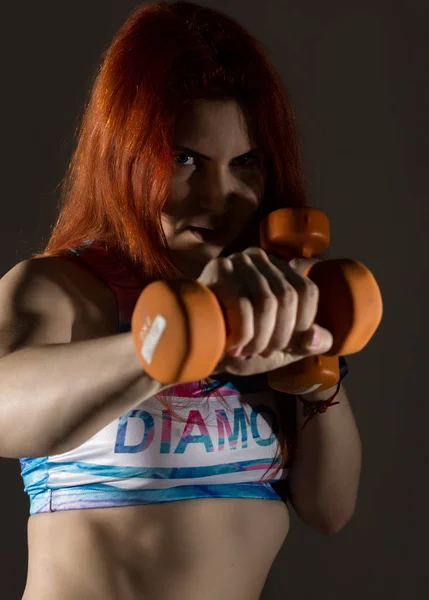 Sporty woman doing exercises, making direct hit with dumbbells. attractive fitness woman — Stock Photo, Image