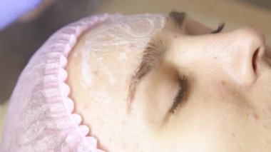 Spa tedavi gören kadın. Masöz temizlikçi kadın yüz Spa'da pamuk temizleme bezi ile