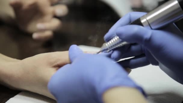 Manikyr gör professionell gel polska manikyr till kvinnlig kund i nagelsalongen. kvinna filspån naglar — Stockvideo