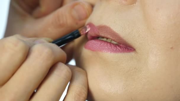 Επαγγελματίας καλλιτέχνης μακιγιάζ εφαρμογή περίγραμμα στα χείλη του μοντέλου. Μόδα βιομηχανία καλλυντικών — Αρχείο Βίντεο