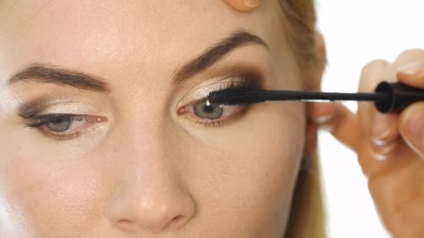 Primer plano del maquillador profesional tiñe los ojos del modelo con un pincel grande. cosméticos de la industria de la moda — Vídeos de Stock