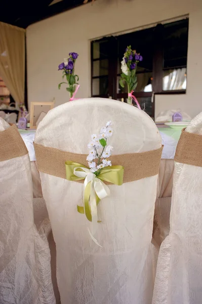 Beautifully decorated table for the wedding ceremony. Served banquet table decorated with fresh flowers in the open air